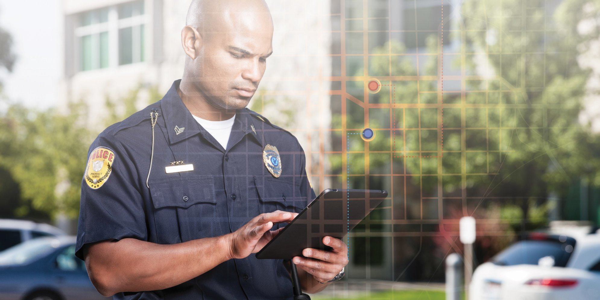 Police officer using a tablet - GIS for Public Safety